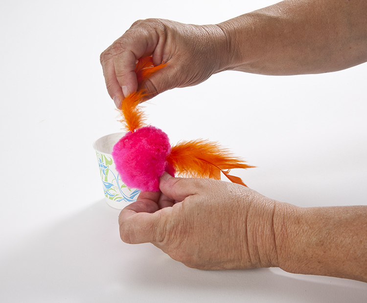 Gluing feathers to flamingo body