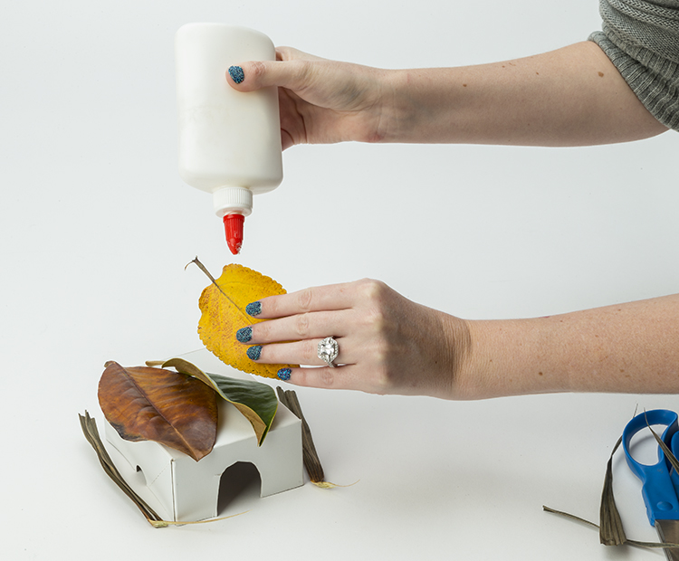 Gluing leaves to the box.