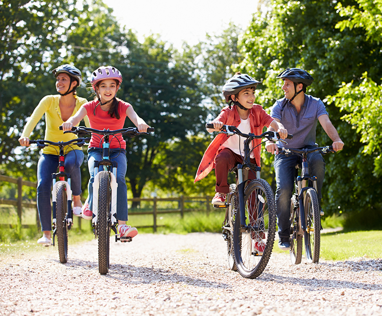 family biking through trail